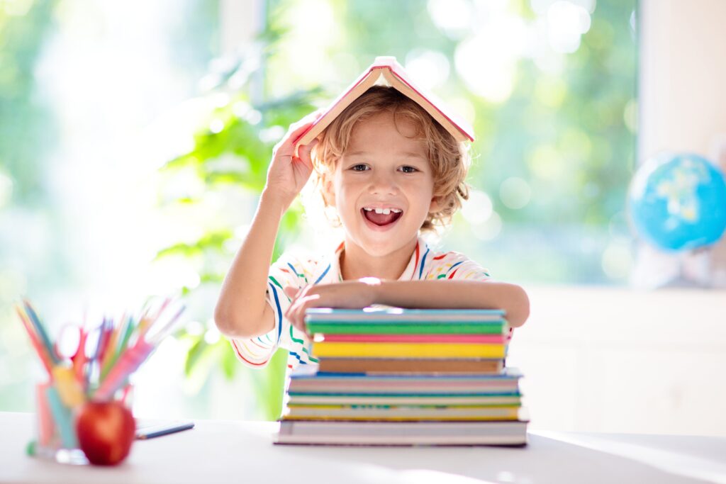 young boy with book on his head