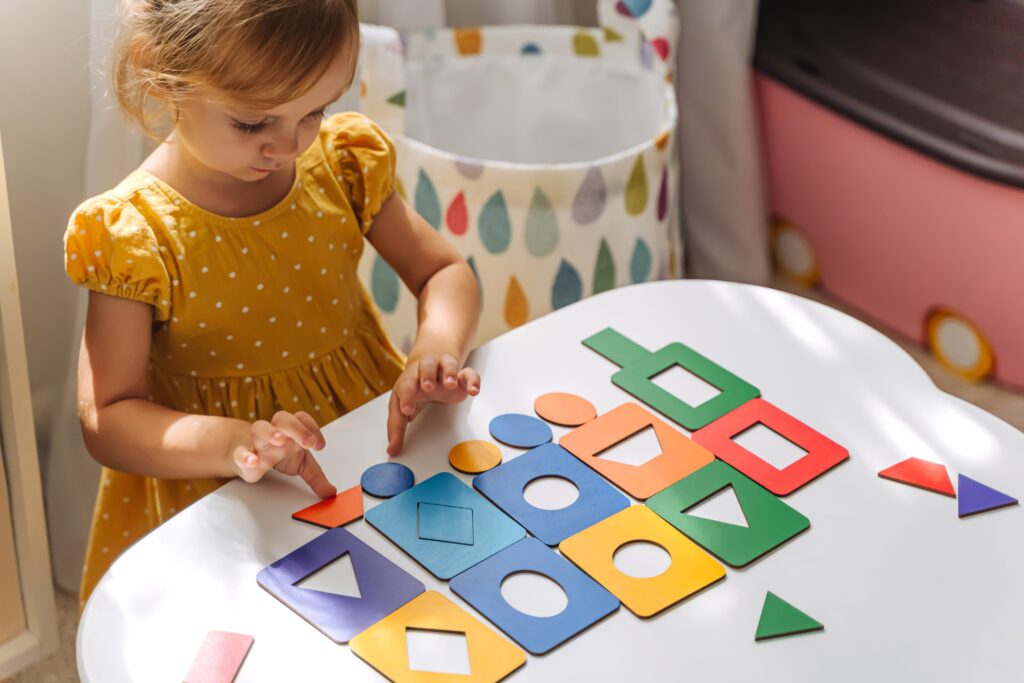 young girl playing with shapes